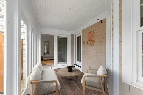 a view of a hallway with wooden floor and closet area