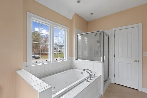 a spacious bathroom with a granite countertop sink mirror and double