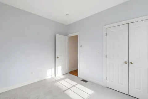 a bedroom with a bed and a night stand