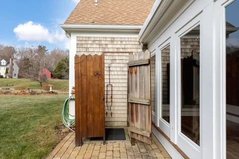 a view of a house with a large window and wooden floor