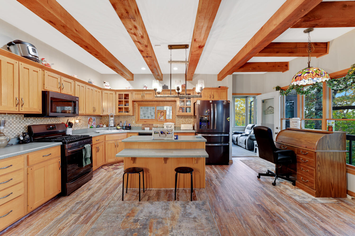 1 River Vly Rnch Road White Heath, IL 61884 - Photo 25 of 66 a kitchen with stainless steel appliances granite countertop a refrigerator a stove top oven a dining table and chairs with wooden floor