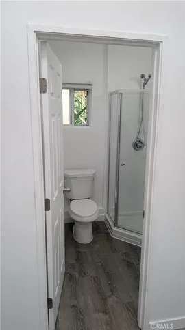 a bathroom with a toilet and a shower