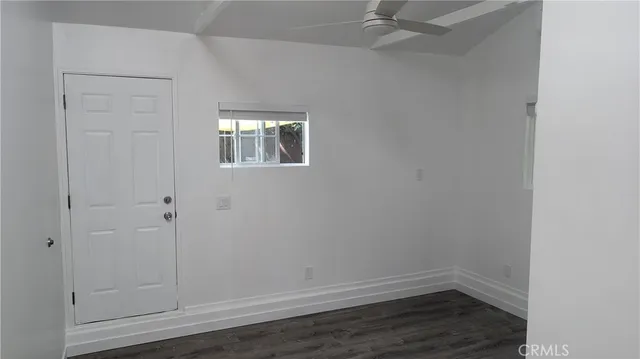 an empty room with wooden floor and closet