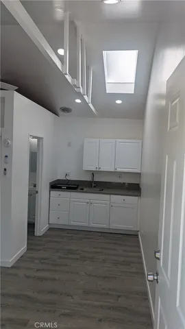 a kitchen with stainless steel appliances kitchen island granite countertop a refrigerator and a stove