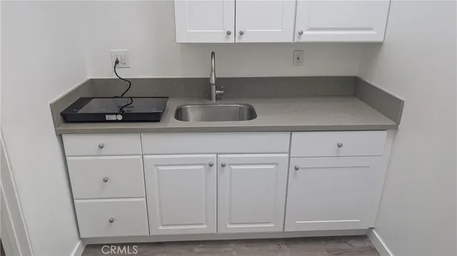 a kitchen with a sink and cabinets
