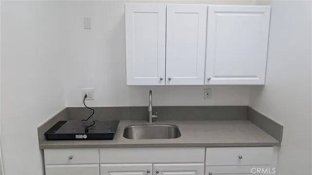 a kitchen with a sink and cabinets