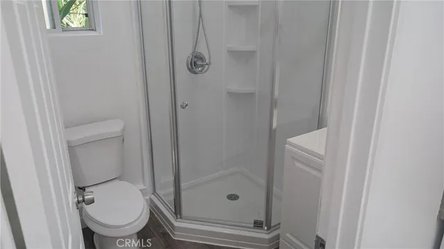 a bathroom with a granite countertop toilet a sink and a mirror