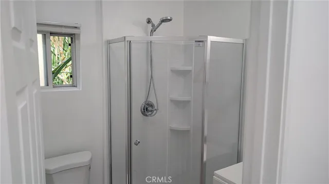 a bathroom with a shower and toilet