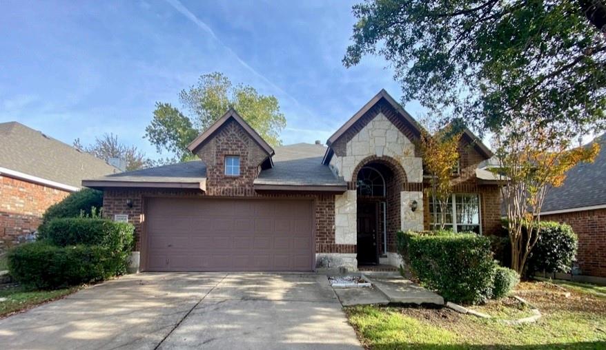 a front view of a house with yard garage and outdoor seating