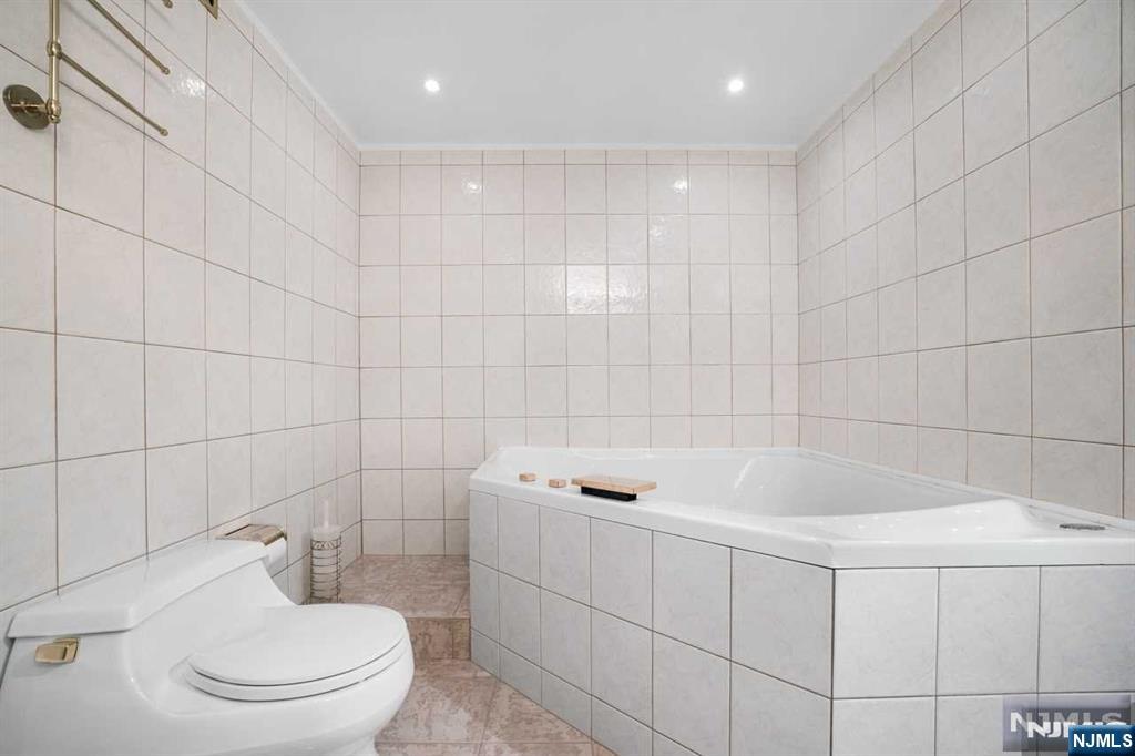 1055 River Road, Unit 905 Edgewater, NJ 07020 - Photo 12 of 26 a bathroom with a toilet and a shower