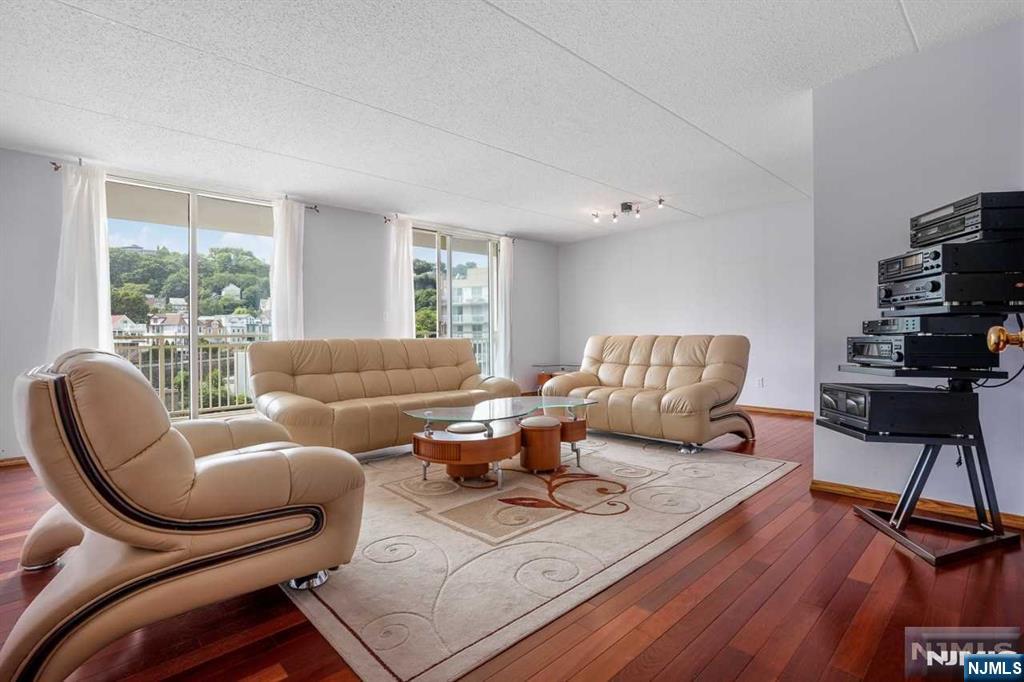 1055 River Road, Unit 905 Edgewater, NJ 07020 - Photo 5 of 26 a living room with furniture or wooden floor and a large window