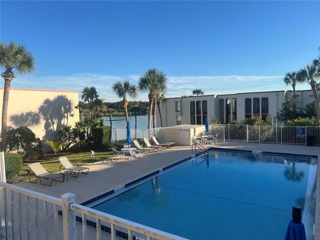 a view of a patio with swimming pool table and chairs