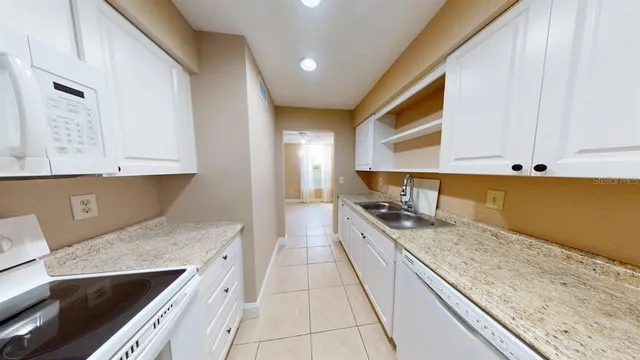 a kitchen with stainless steel appliances granite countertop a sink and cabinets
