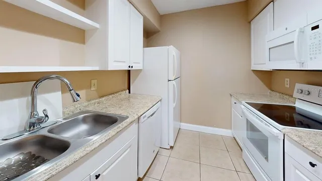 a kitchen with a sink and a refrigerator