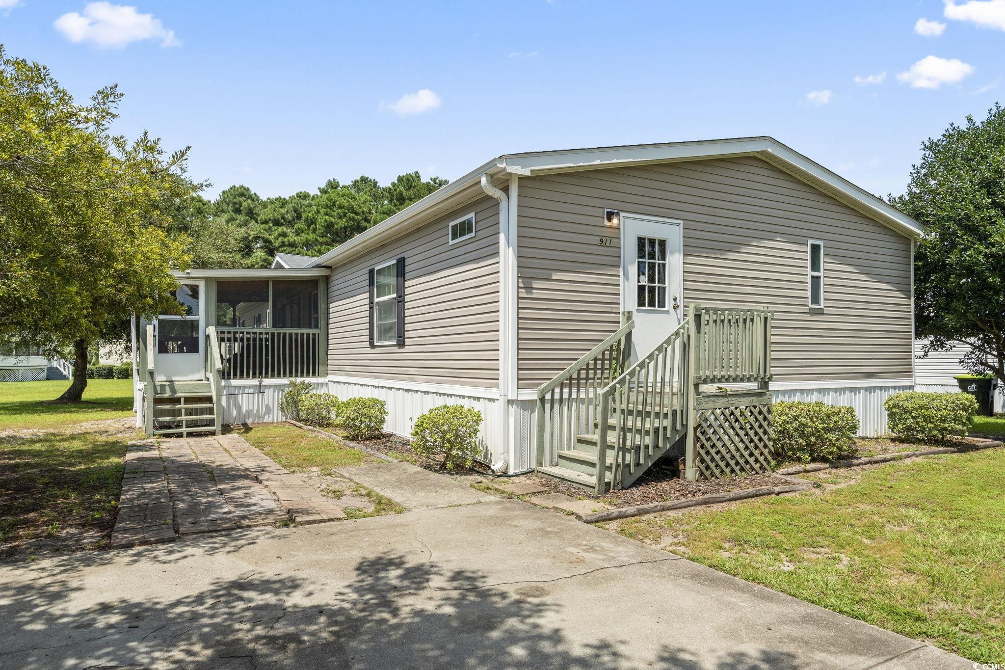 911 Old Magnolia Drive Conway, SC 29526 - Photo 1 of 35 Manufactured / mobile home featuring a sunroom and a front yard