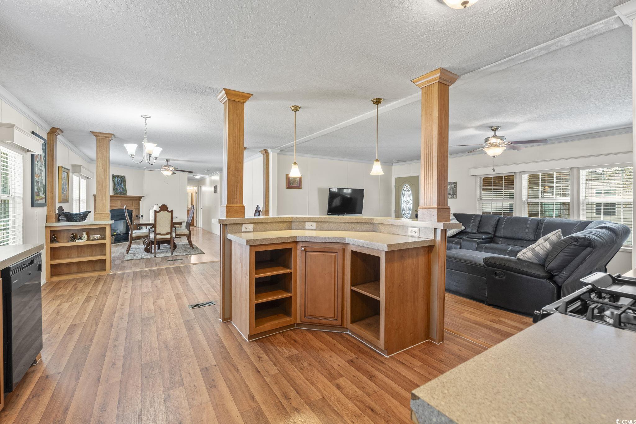 911 Old Magnolia Drive Conway, SC 29526 - Photo 34 of 35 Kitchen with ornate columns, open floor plan, open shelves, light countertops, and light wood-type flooring