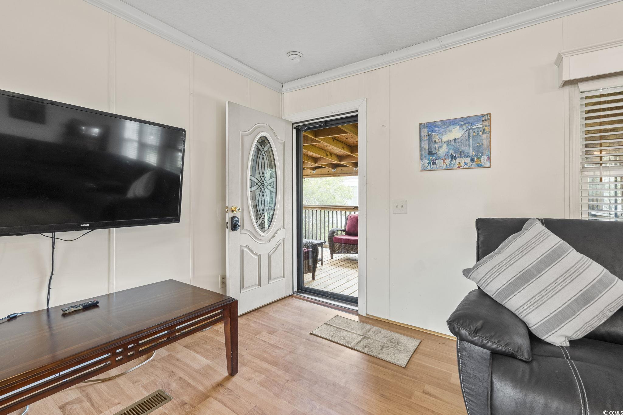 911 Old Magnolia Drive Conway, SC 29526 - Photo 26 of 35 Entrance foyer featuring ornamental molding, a decorative wall, and light wood finished floors