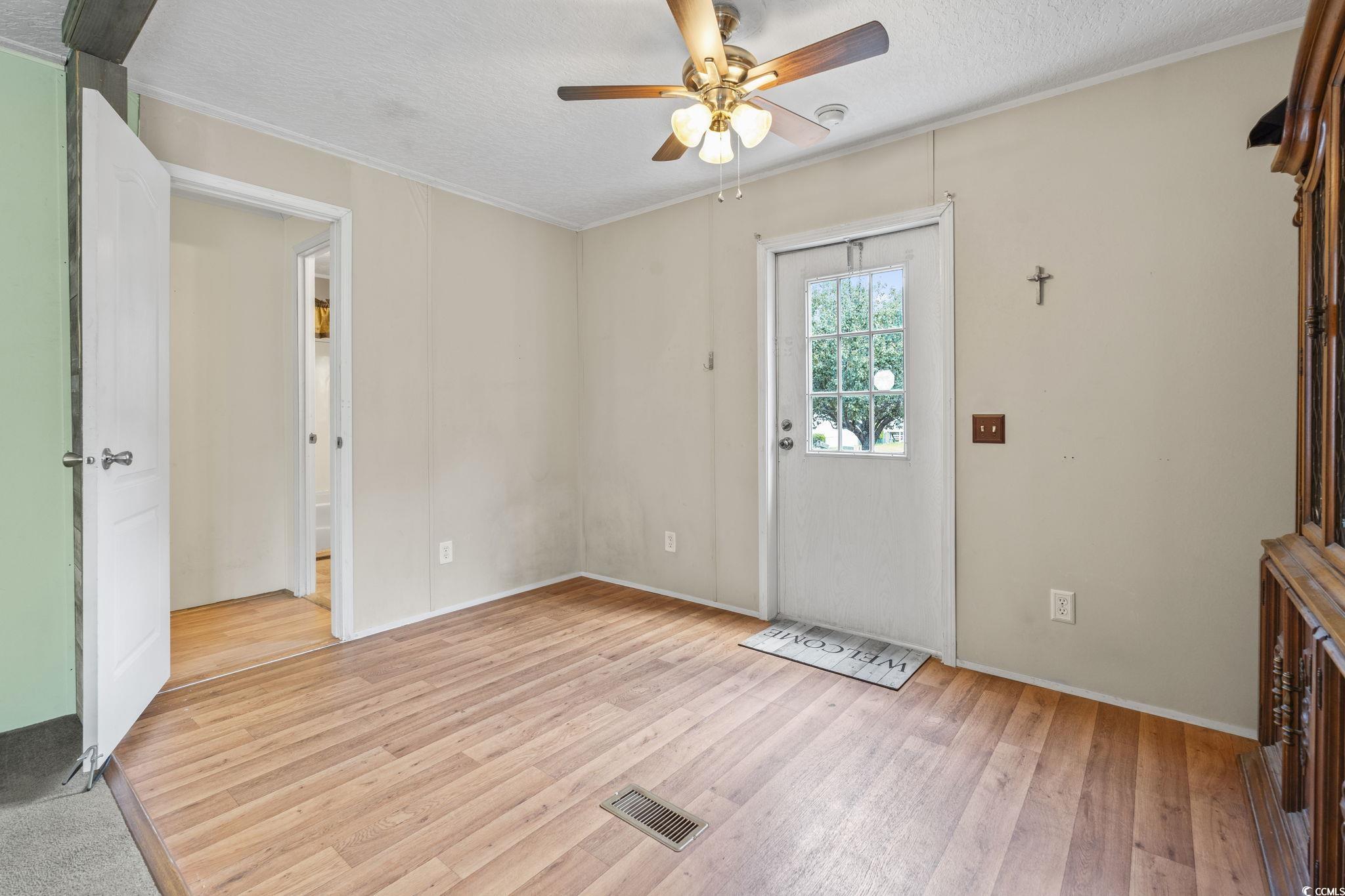 911 Old Magnolia Drive Conway, SC 29526 - Photo 27 of 35 Foyer featuring crown molding, a textured ceiling, ceiling fan, and light wood-type flooring