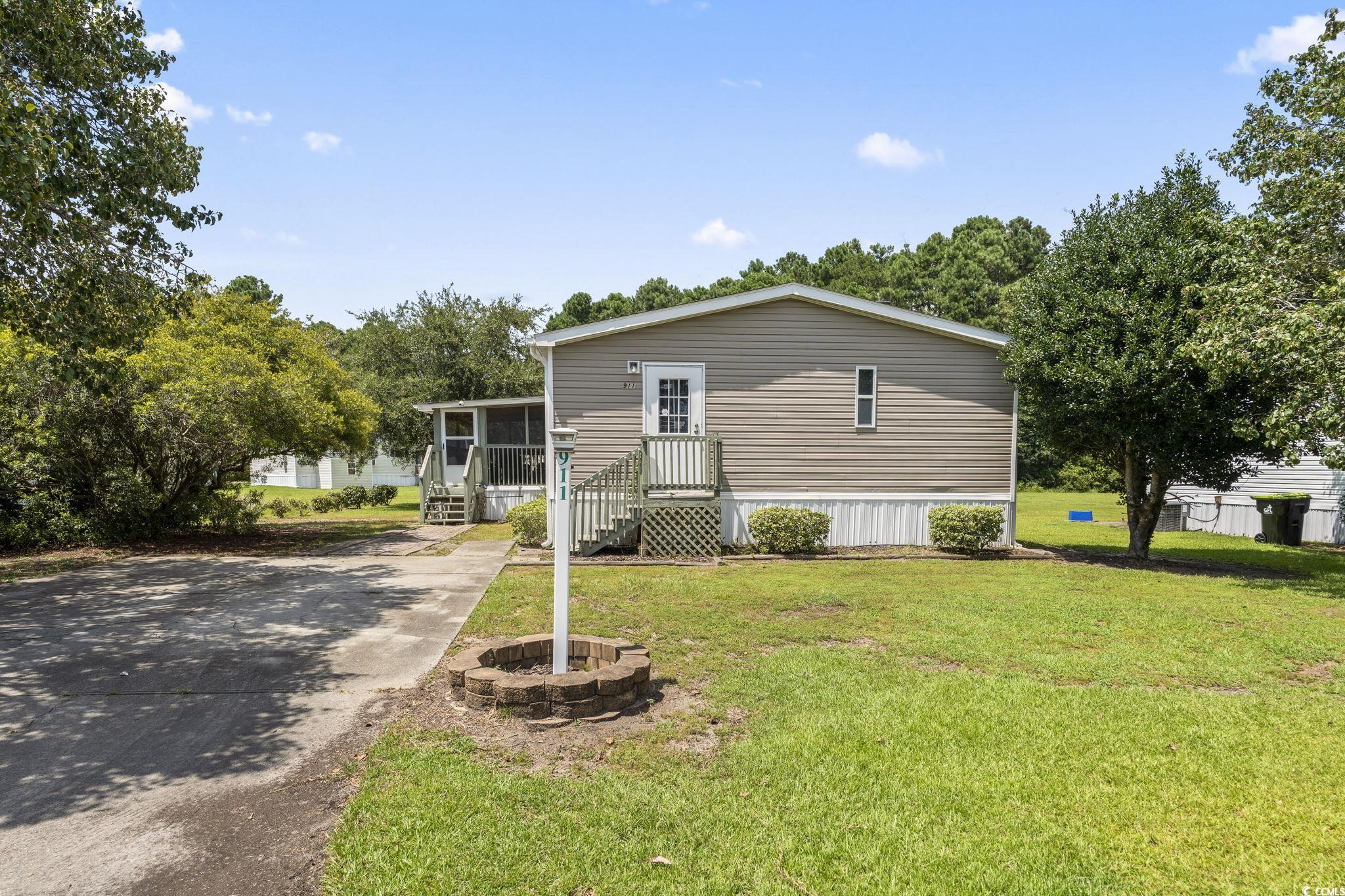 911 Old Magnolia Drive Conway, SC 29526 - Photo 30 of 35 Manufactured / mobile home with driveway, a sunroom, and a front yard