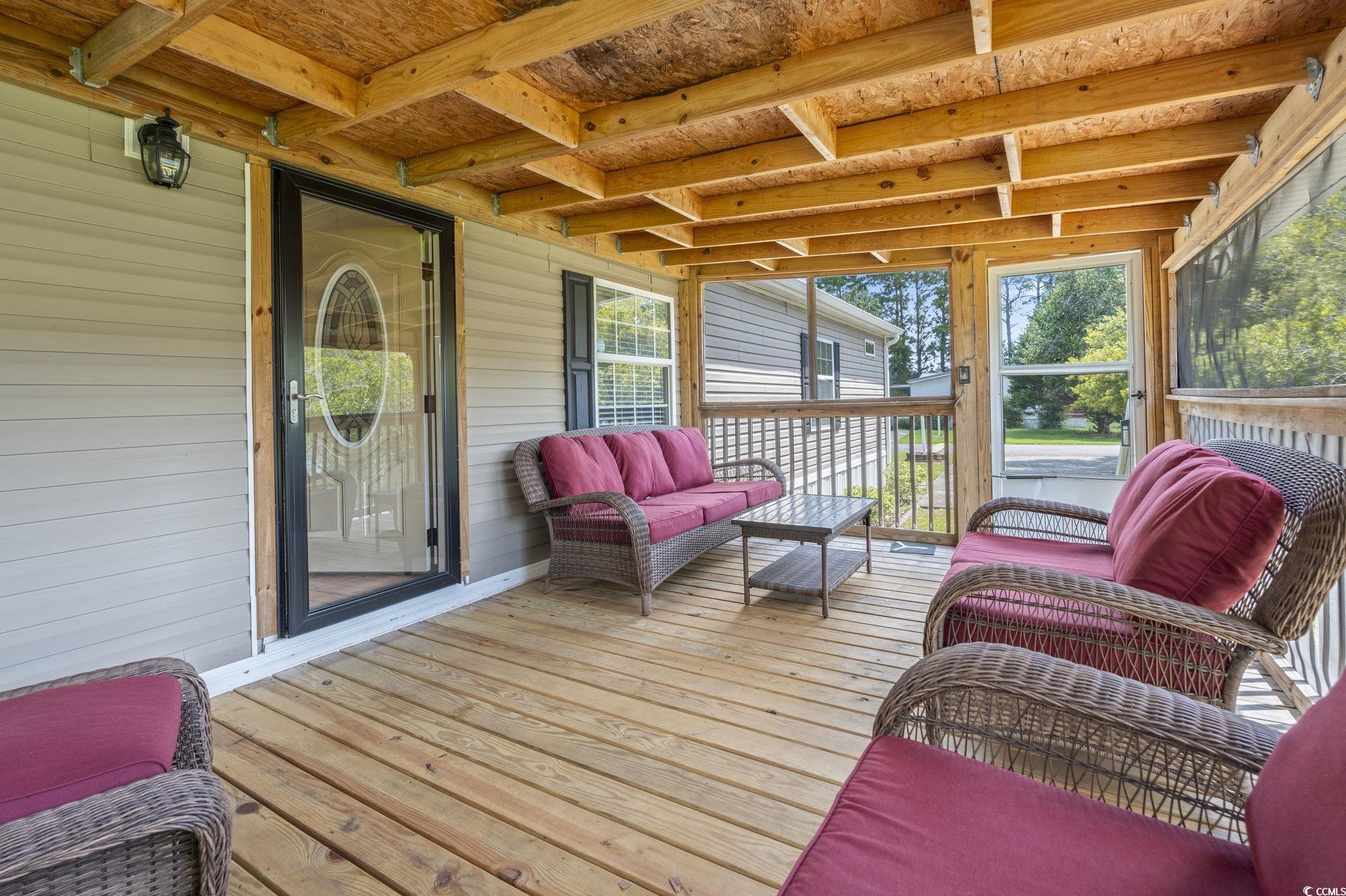911 Old Magnolia Drive Conway, SC 29526 - Photo 10 of 35 Wooden deck with an outdoor hangout area