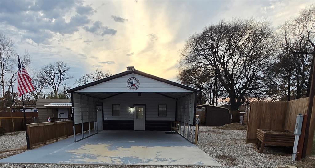 121 Arrowhead Quitman, TX 75783 - Photo 1 of 14 a front view of a house with a garage