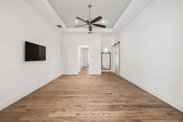 a spacious bathroom with double vanity sinks a mirror and a bathtub