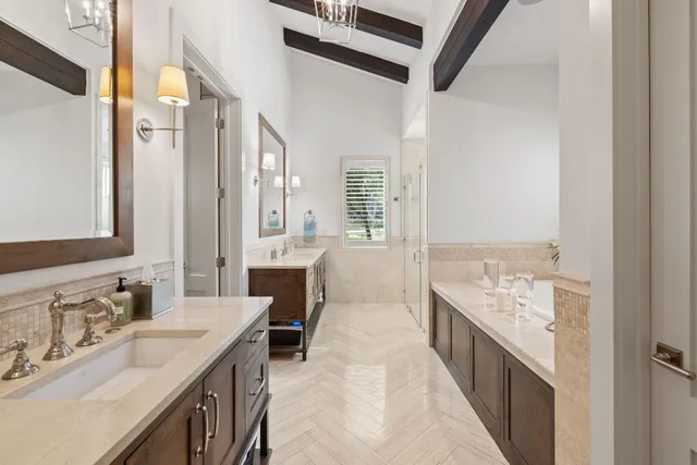 a en suite bathroom with a double vanity sink and a mirror