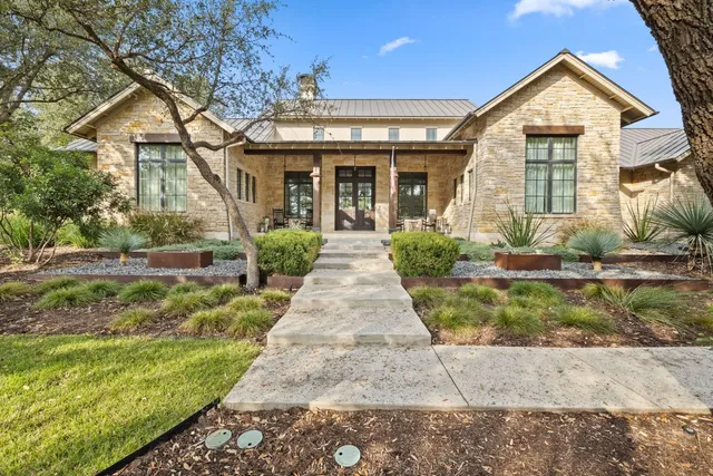 a living room with fireplace furniture and a large window
