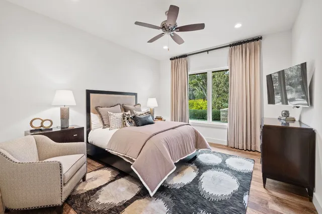 a bathroom with a granite countertop sink toilet and mirror