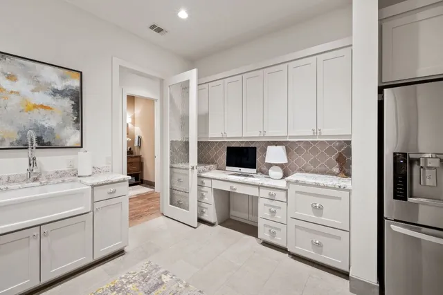 a bathroom with a granite countertop sink toilet and mirror