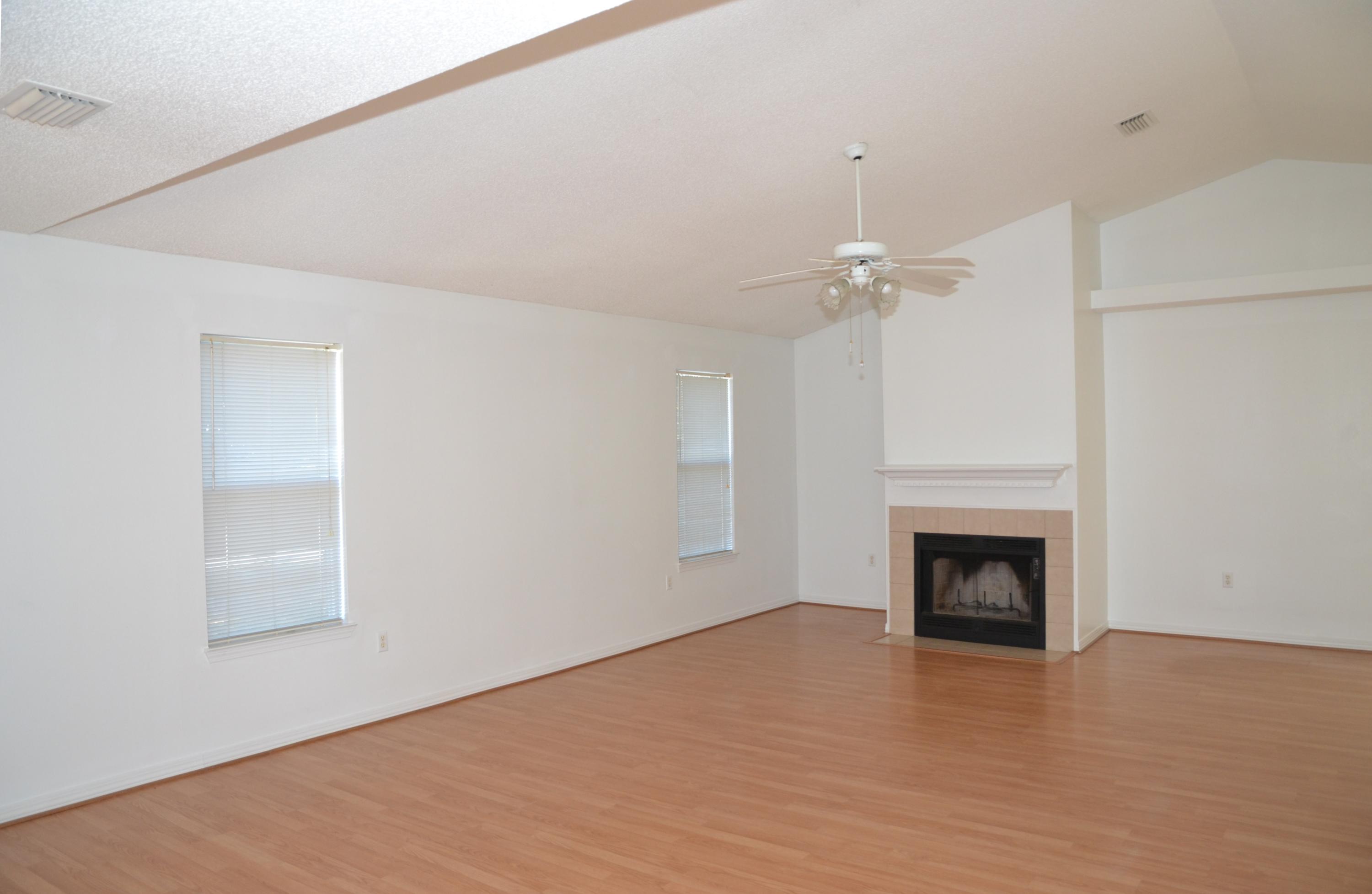 729 Riva Ridge Drive Crestview, FL 32539 - Photo 3 of 40 a view of an empty room with a fireplace and a window