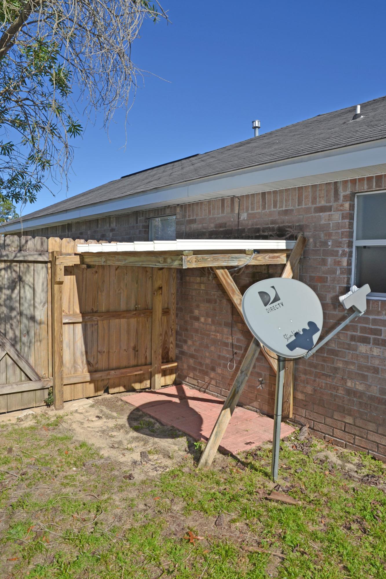 729 Riva Ridge Drive Crestview, FL 32539 - Photo 39 of 40 a view of a backyard with table and chairs