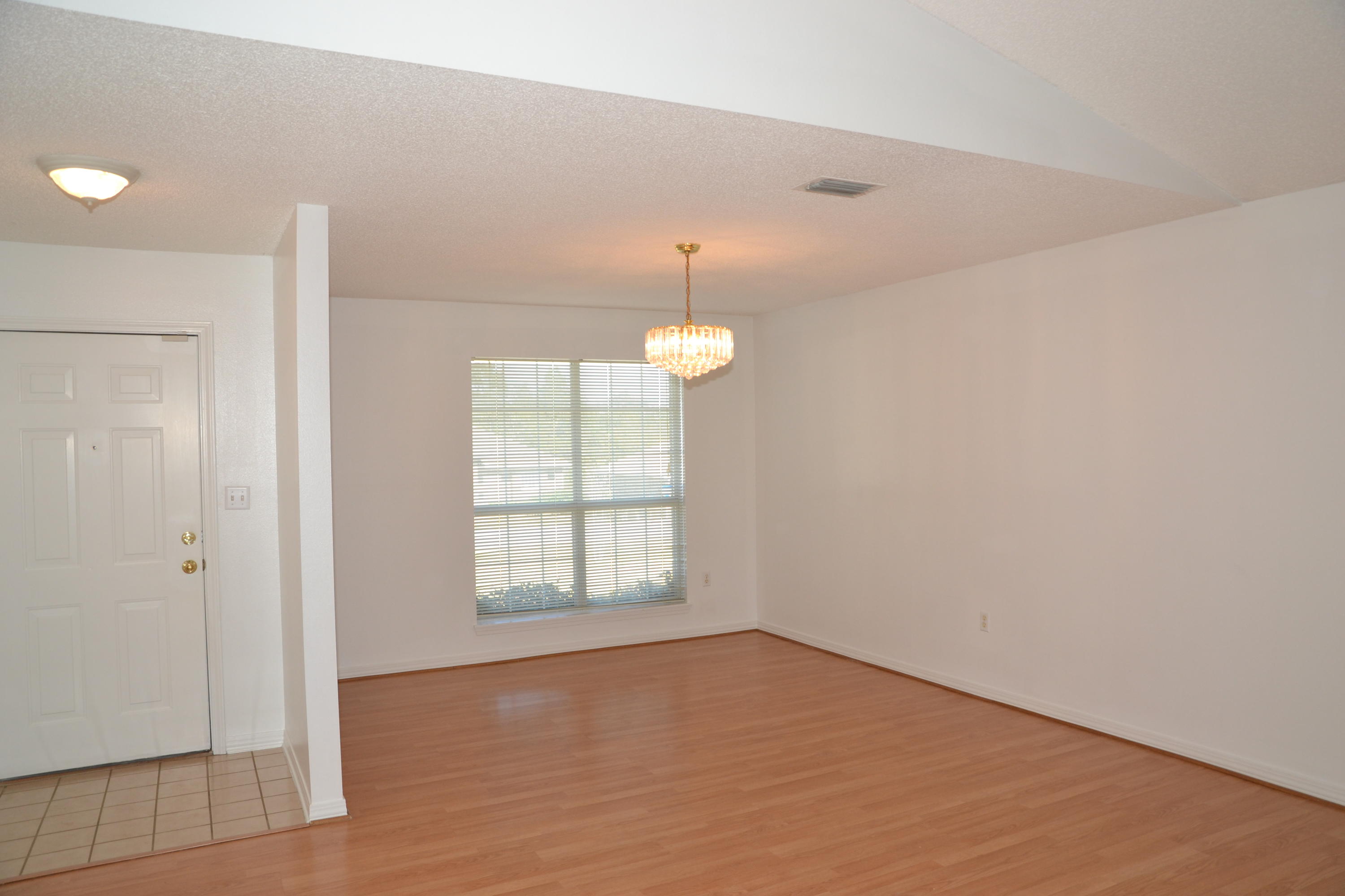 729 Riva Ridge Drive Crestview, FL 32539 - Photo 7 of 40 wooden floor in an empty room with a window