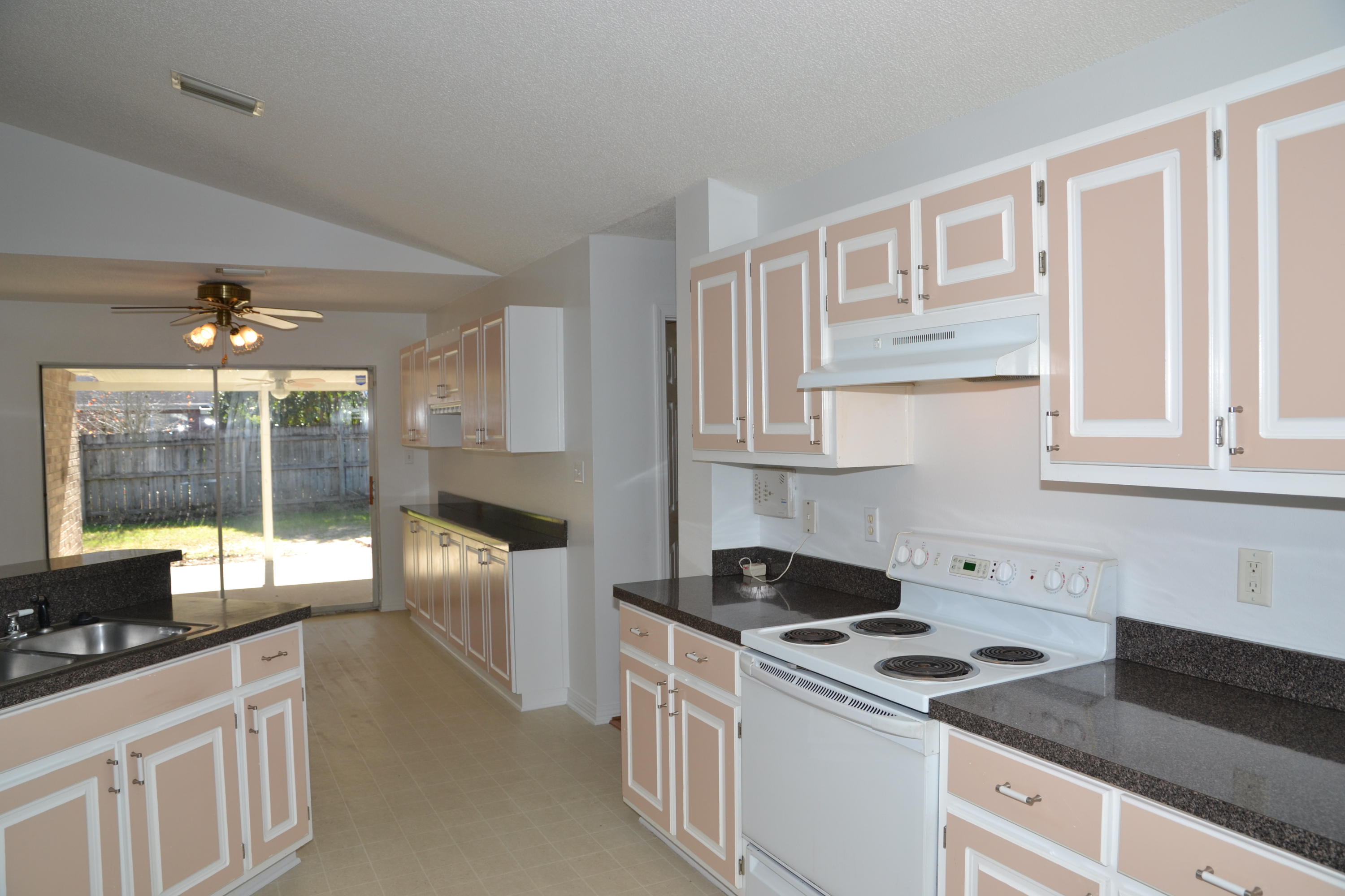 729 Riva Ridge Drive Crestview, FL 32539 - Photo 8 of 40 a kitchen that has a lot of cabinets in it and wooden floors
