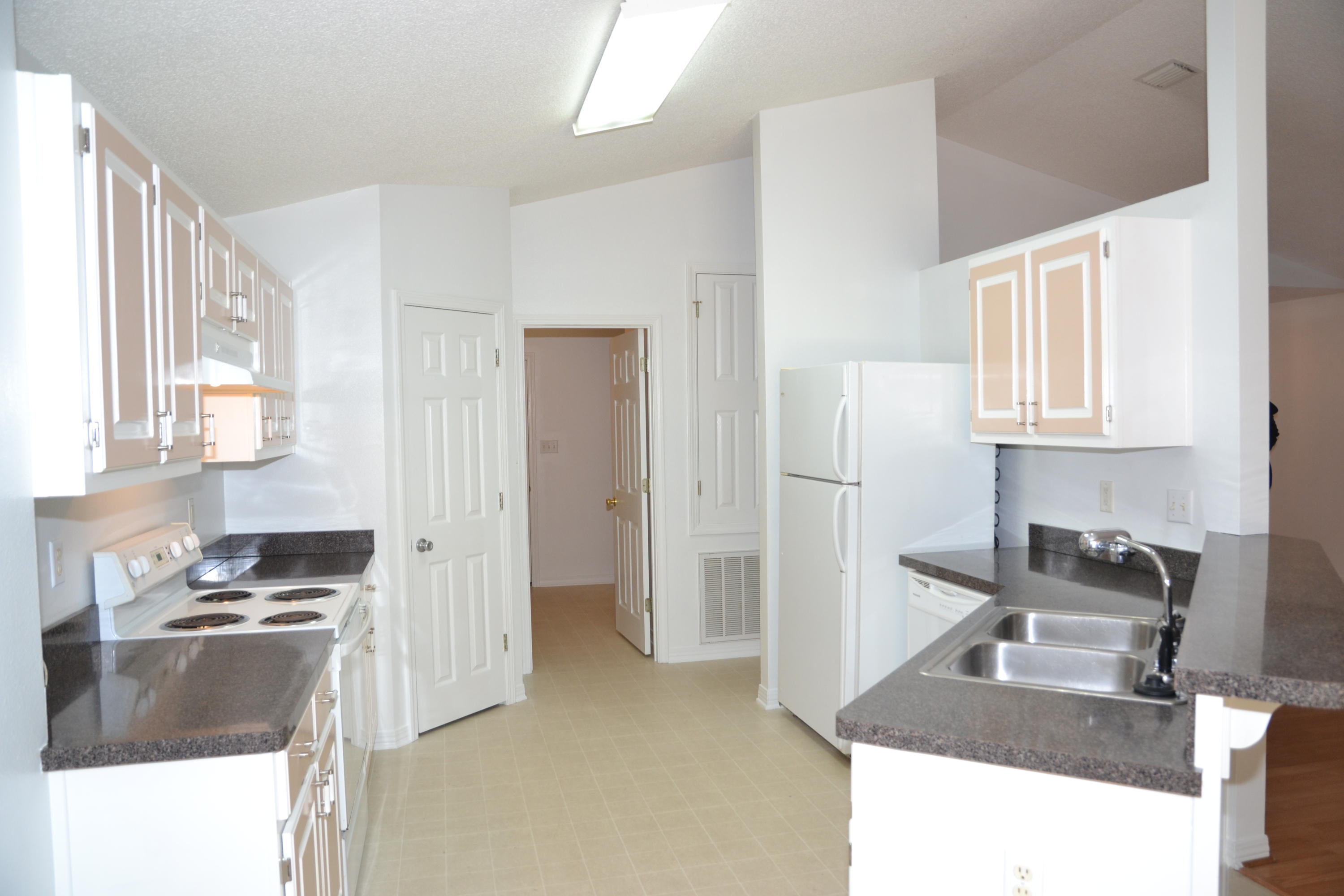 729 Riva Ridge Drive Crestview, FL 32539 - Photo 10 of 40 a kitchen with granite countertop a refrigerator stove and sink