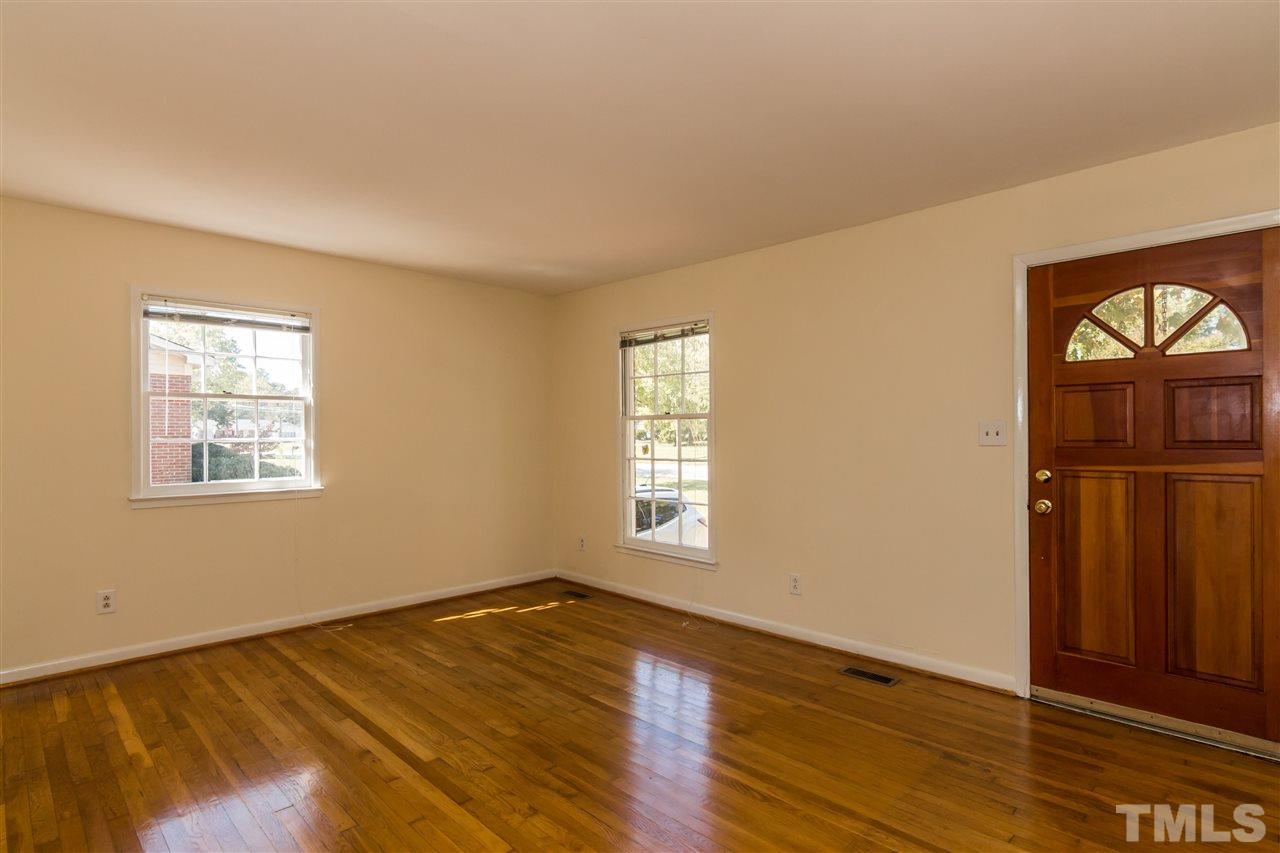 1506 Sedwick Road Durham, NC 27713 - Photo 2 of 21 a view of empty room with wooden floor and fan