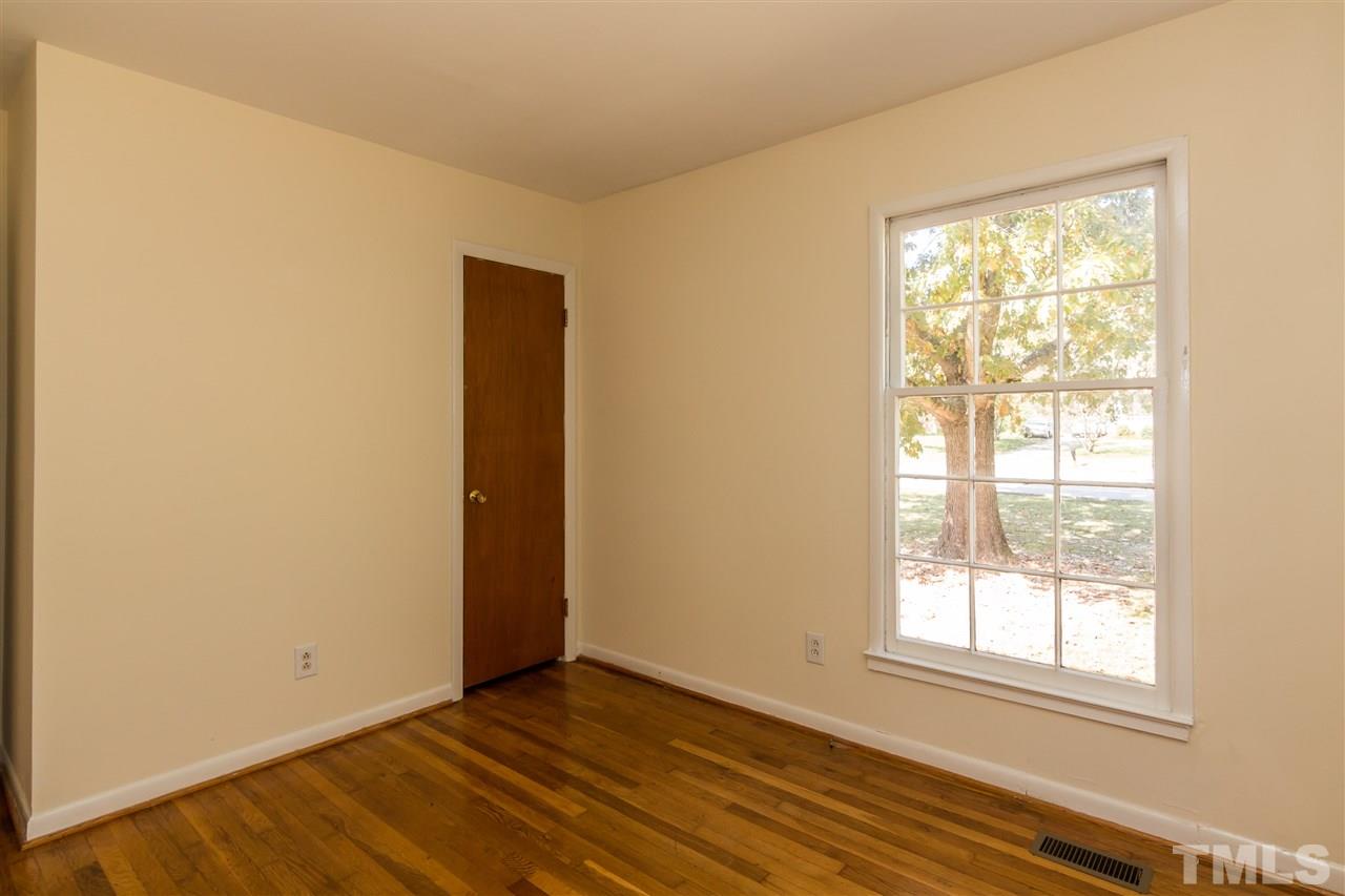 1506 Sedwick Road Durham, NC 27713 - Photo 11 of 21 an empty room with wooden floor and windows