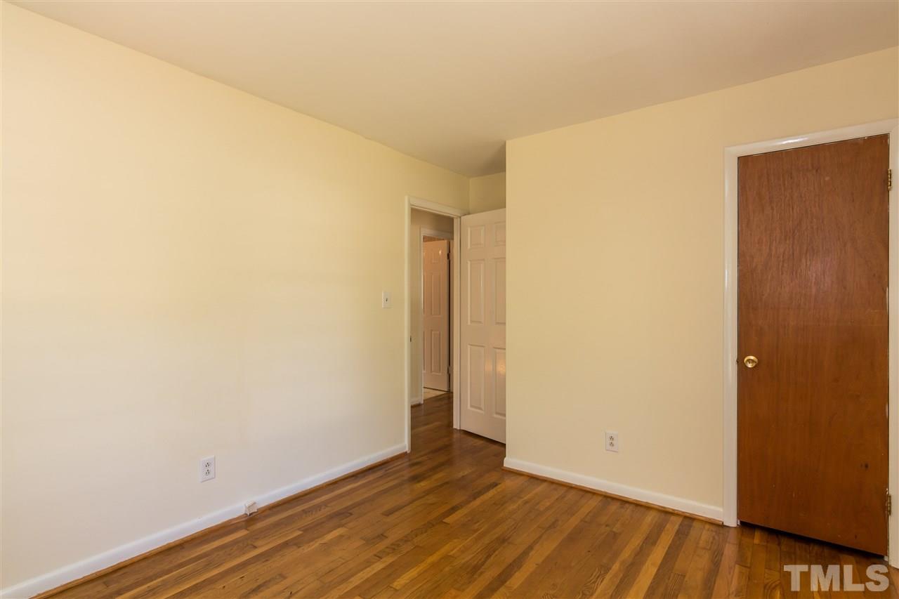 1506 Sedwick Road Durham, NC 27713 - Photo 12 of 21 a view of an empty room with wooden floor