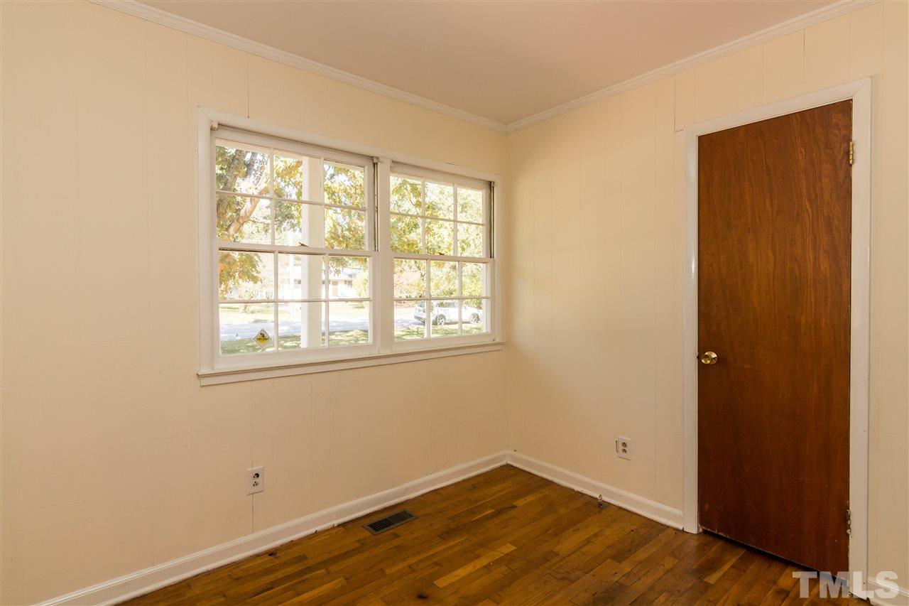 1506 Sedwick Road Durham, NC 27713 - Photo 13 of 21 an empty room with wooden floor and windows