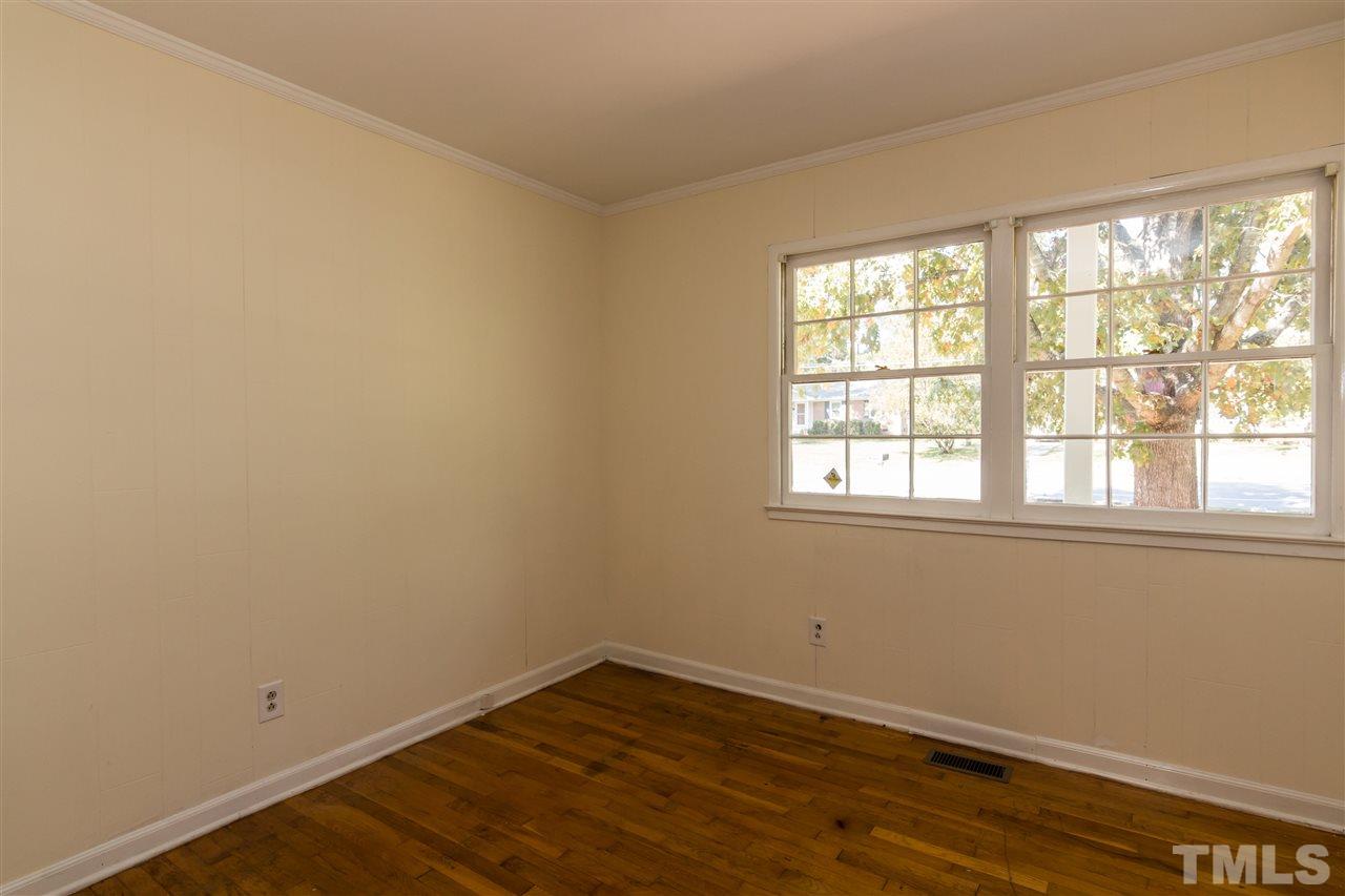 1506 Sedwick Road Durham, NC 27713 - Photo 15 of 21 an empty room with wooden floor and windows