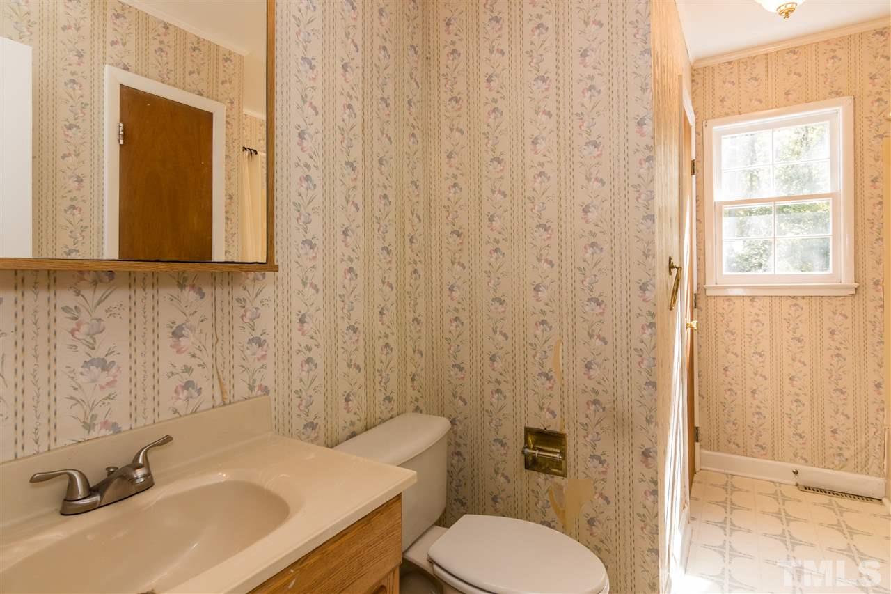 1506 Sedwick Road Durham, NC 27713 - Photo 16 of 21 a bathroom with a sink toilet and shower