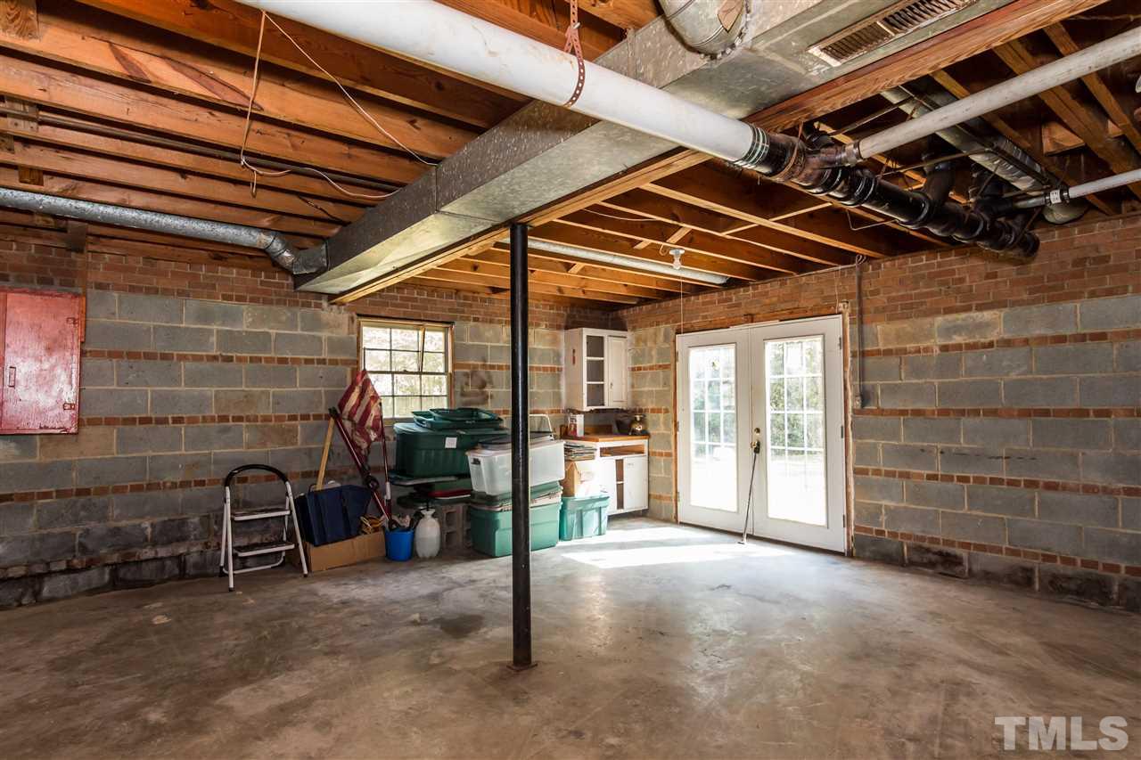 1506 Sedwick Road Durham, NC 27713 - Photo 18 of 21 a view of an empty room with a fireplace