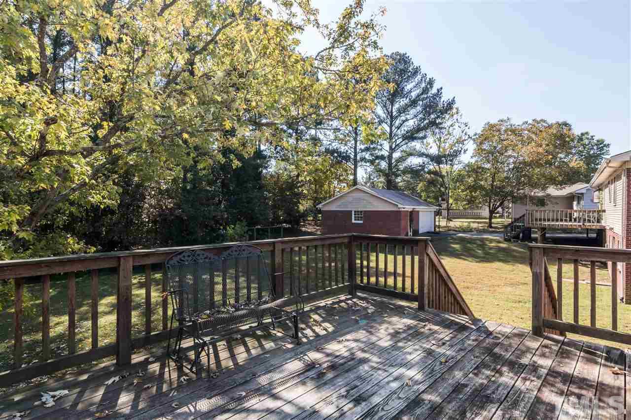 1506 Sedwick Road Durham, NC 27713 - Photo 20 of 21 a view of a wooden deck with large trees
