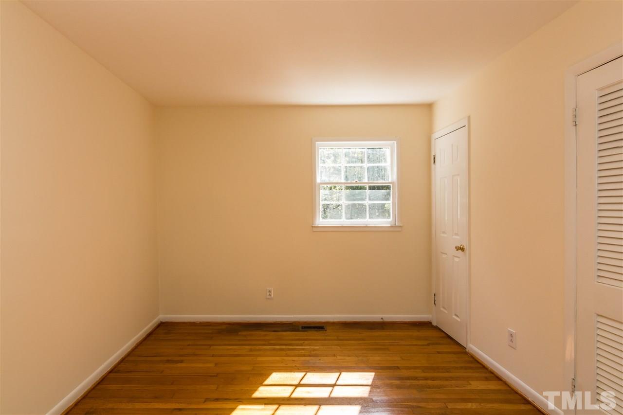 1506 Sedwick Road Durham, NC 27713 - Photo 7 of 21 an empty room with wooden floor and windows
