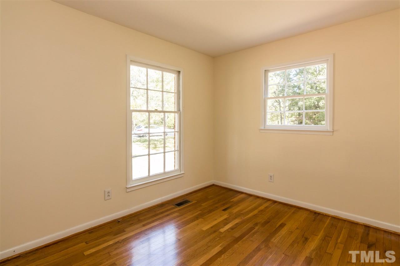 1506 Sedwick Road Durham, NC 27713 - Photo 10 of 21 a view of empty room with wooden floor and fan