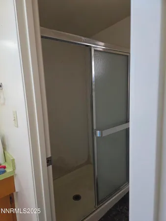 a bathroom with a glass shower door