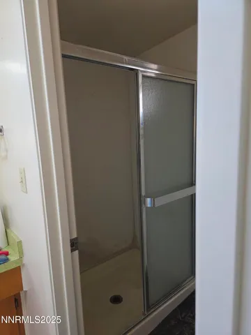 a bathroom with a glass shower door