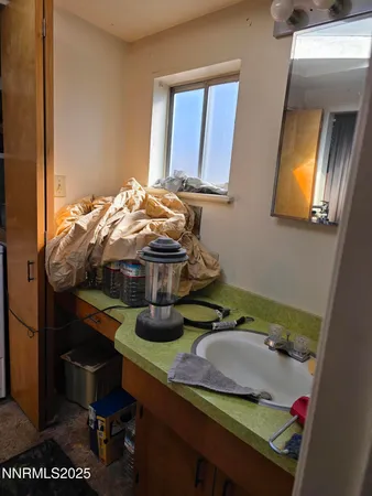a white toilet sitting in a bathroom next to a window