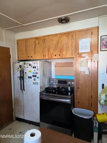 a kitchen with a refrigerator and a stove