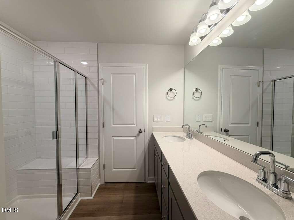 5024 Reader Way Durham, NC 27703 - Photo 19 of 26 a bathroom with a sink a toilet and shower